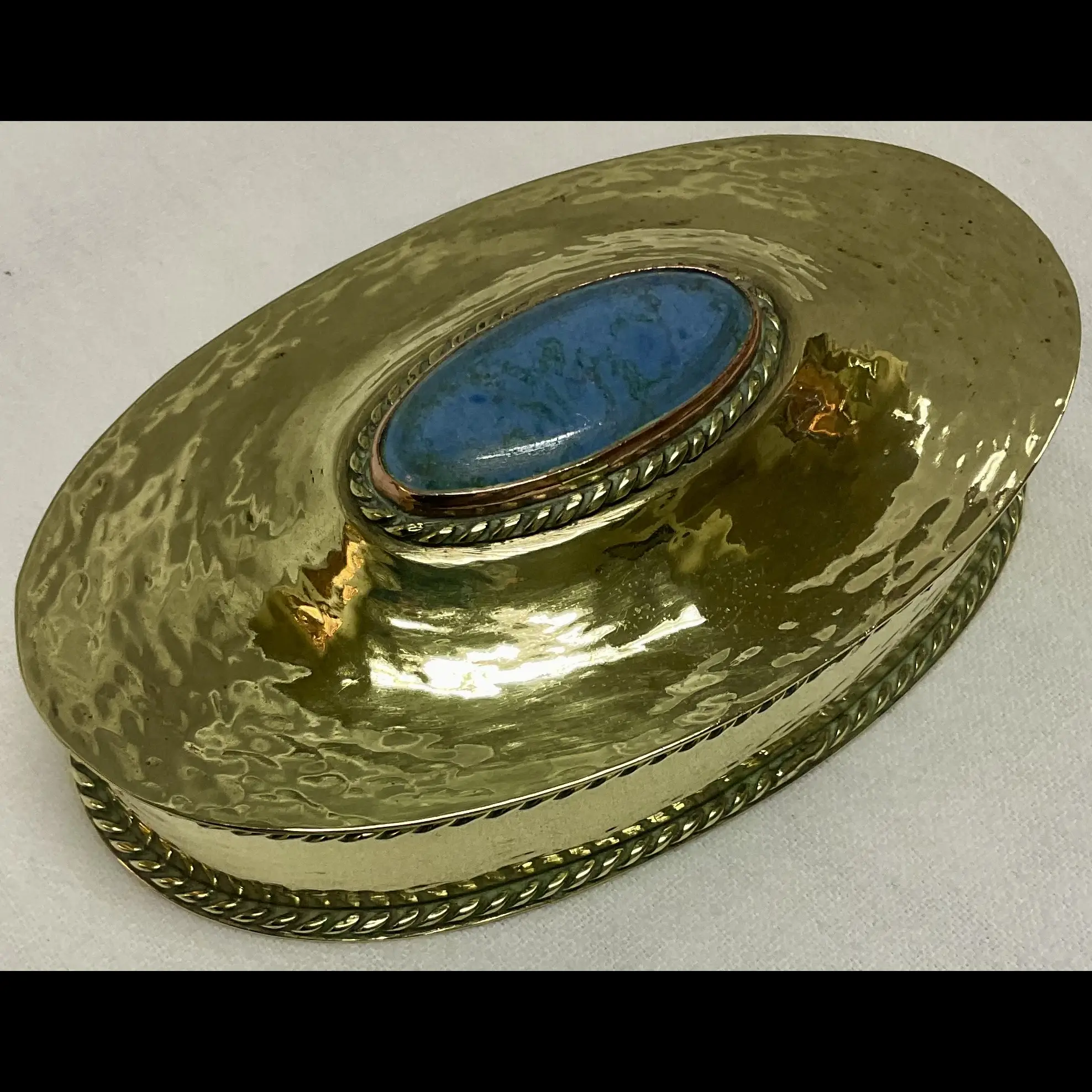 arts and crafts hammered brass oval box with wire work mounted ruskin cabochon