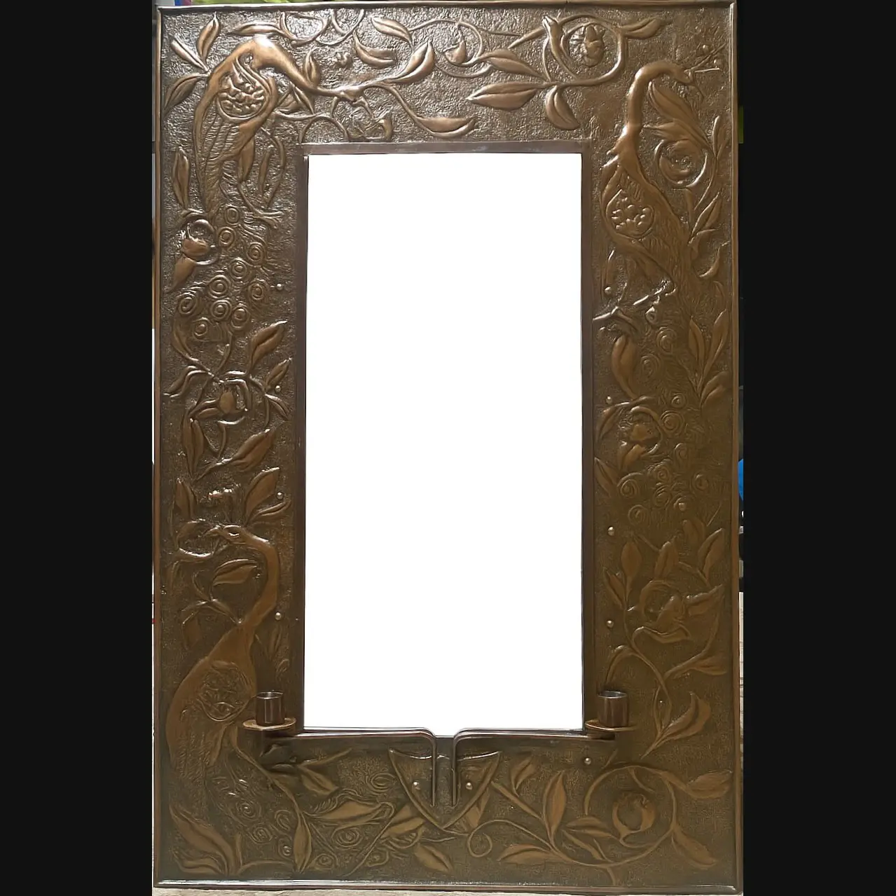 large arts and crafts copper mirror with candle sconces worked with peacocks and pomegranates c1900 10