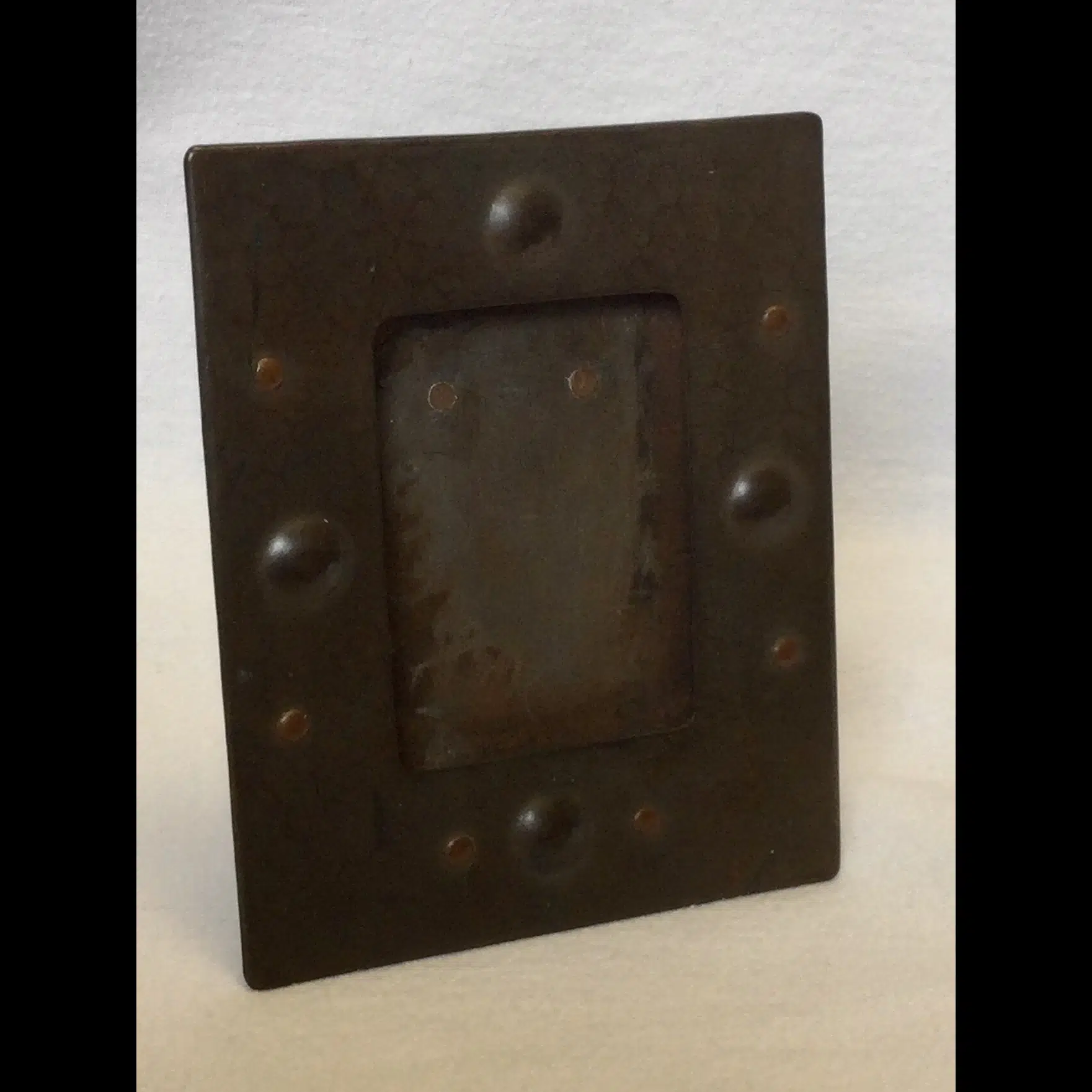 newlyn copper photo frame with planished and riveted decoration