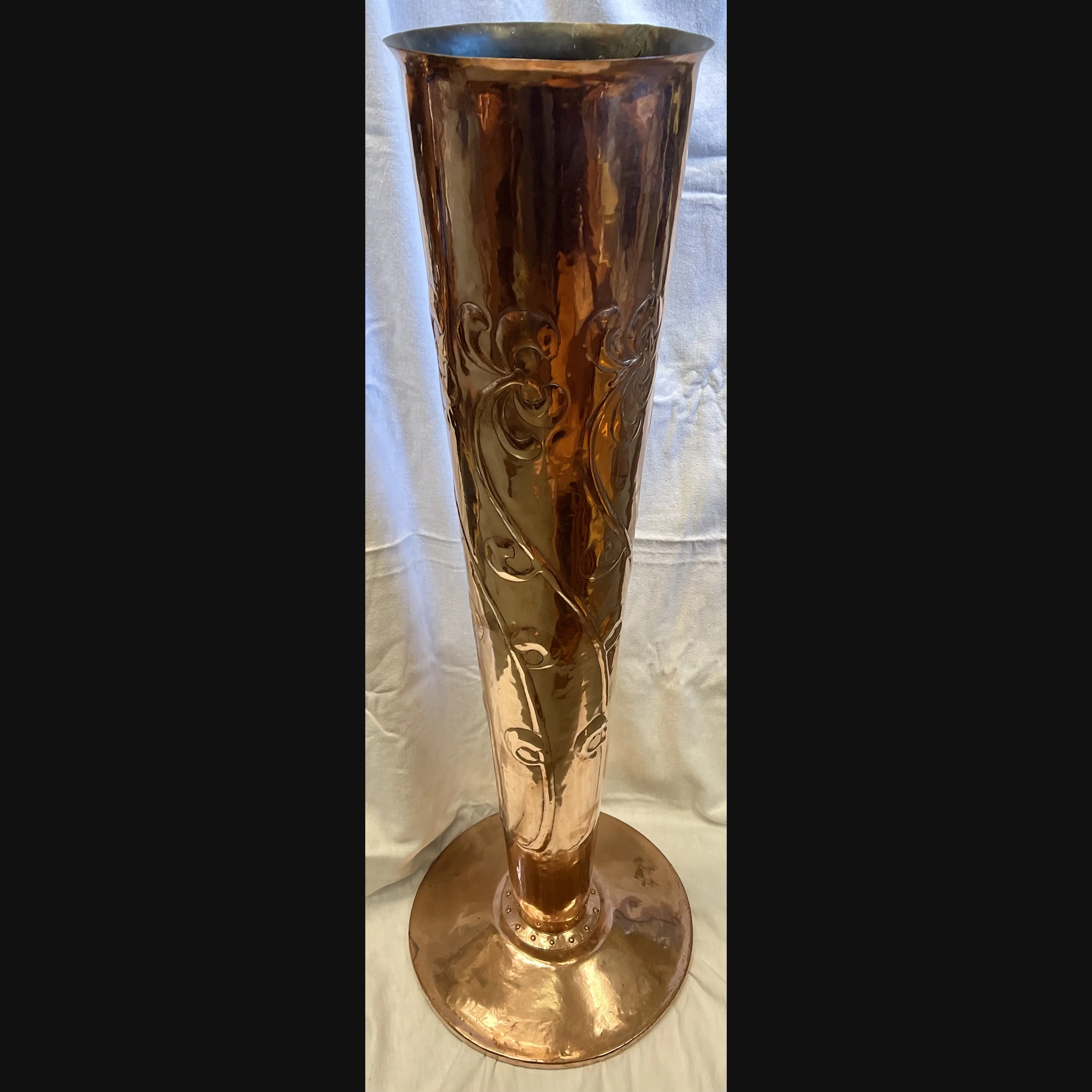 massive arts and crafts copper vase with art nouveau floral decoration full riveted seam and domed foot